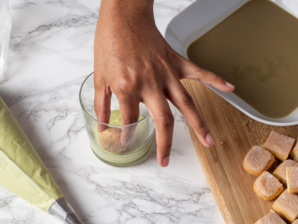 Placing a layer of ladyfinger pieces in mascarpone cream