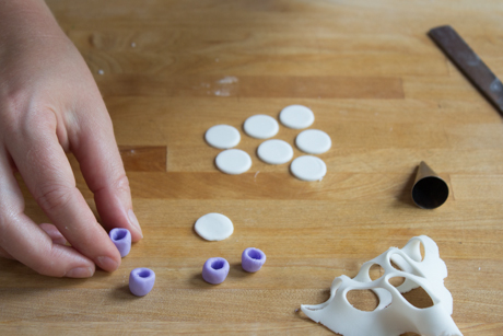 16. Make a tea cup saucer by rolling out a small amount of fondant and cutting small circles with a piping tip. Place the cup on the saucer with a little bit of water. 