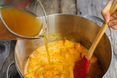 8. Pour the coconut milk and vegetable stock over the pumpkin and bring to a boil and simmer for 10-15 minutes. 