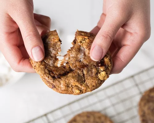 S'mores cookies pulled apart with two hands