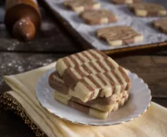 Checkerboard Icebox Cookies stacked on a white plate