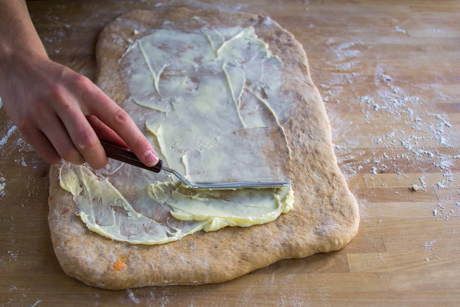 24. Spread dough with butter